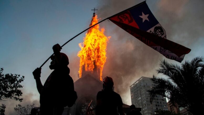 Chileans mark anniversary of mass protests with peaceful rallies in the morning and riots and looting at night